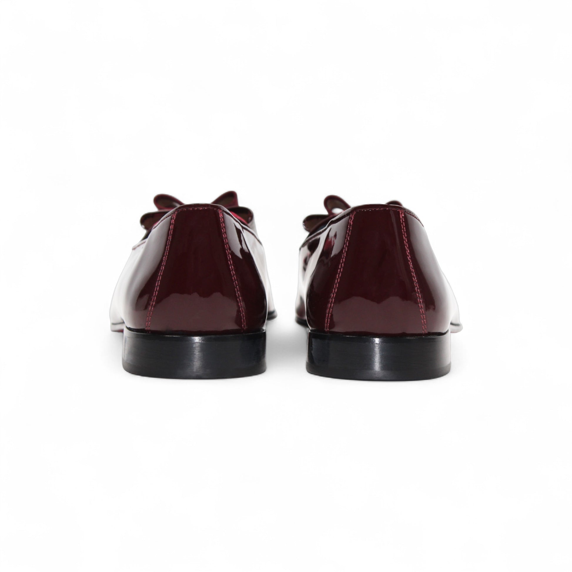 The Duca Amalfi Burgundy by Duca Di Matiste, a burgundy patent leather loafer with a low heel and matching bow, is shown side view on white, capturing refined Italian luxury and expert craftsmanship.