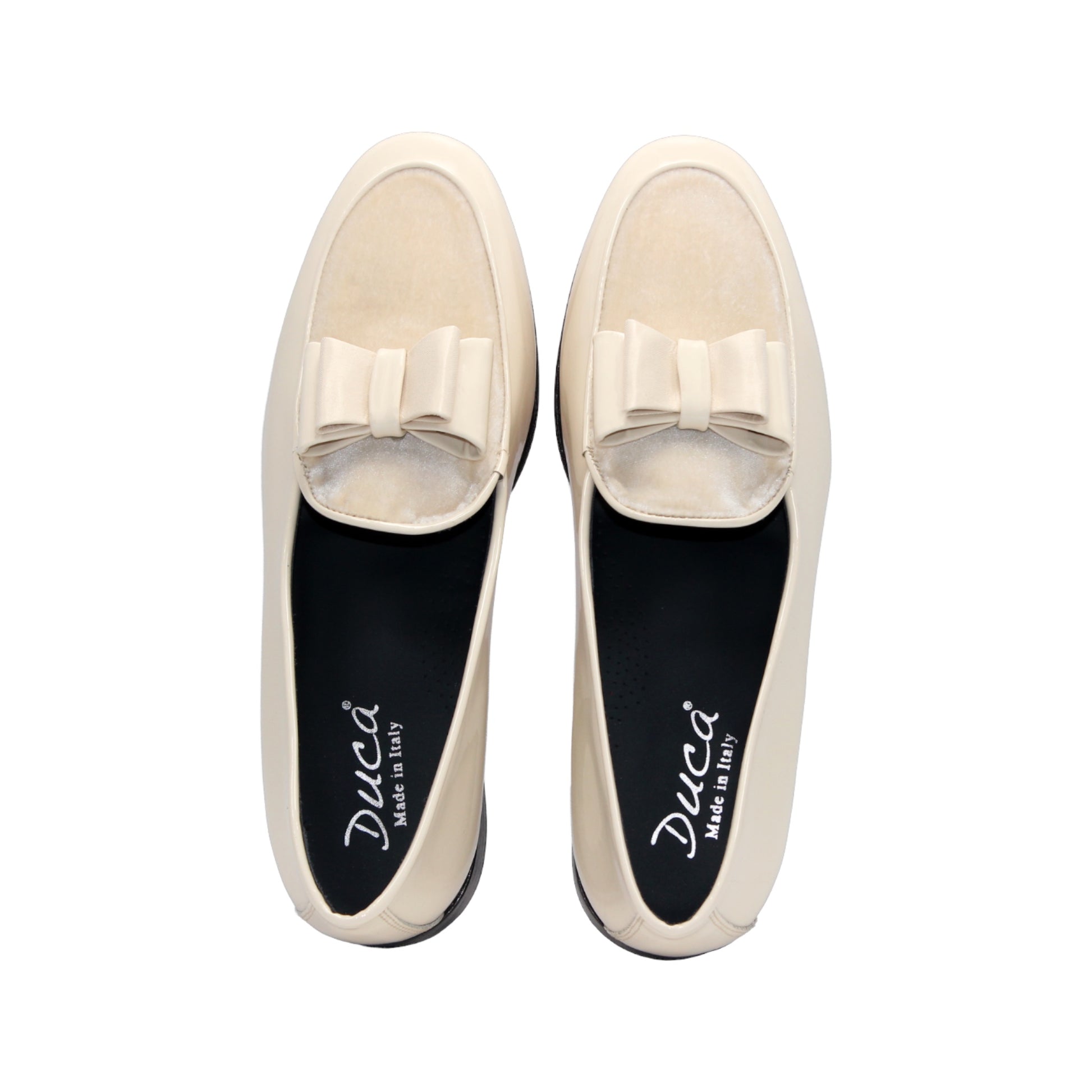 The Duca Di Matiste Duca Amalfi Cream is a cream leather loafer inspired by Amalfi Italian style, featuring a low black heel and a decorative bow detail.