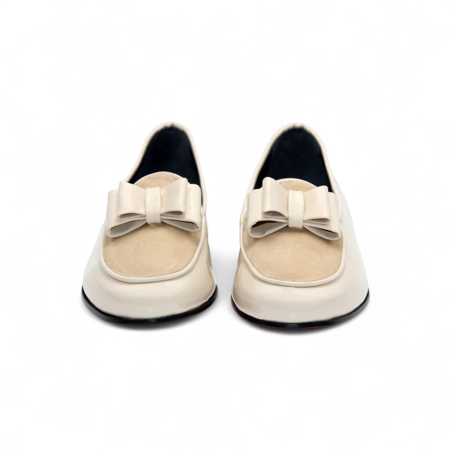 The Duca Di Matiste Duca Amalfi Cream is a cream leather loafer inspired by Amalfi Italian style, featuring a low black heel and a decorative bow detail.