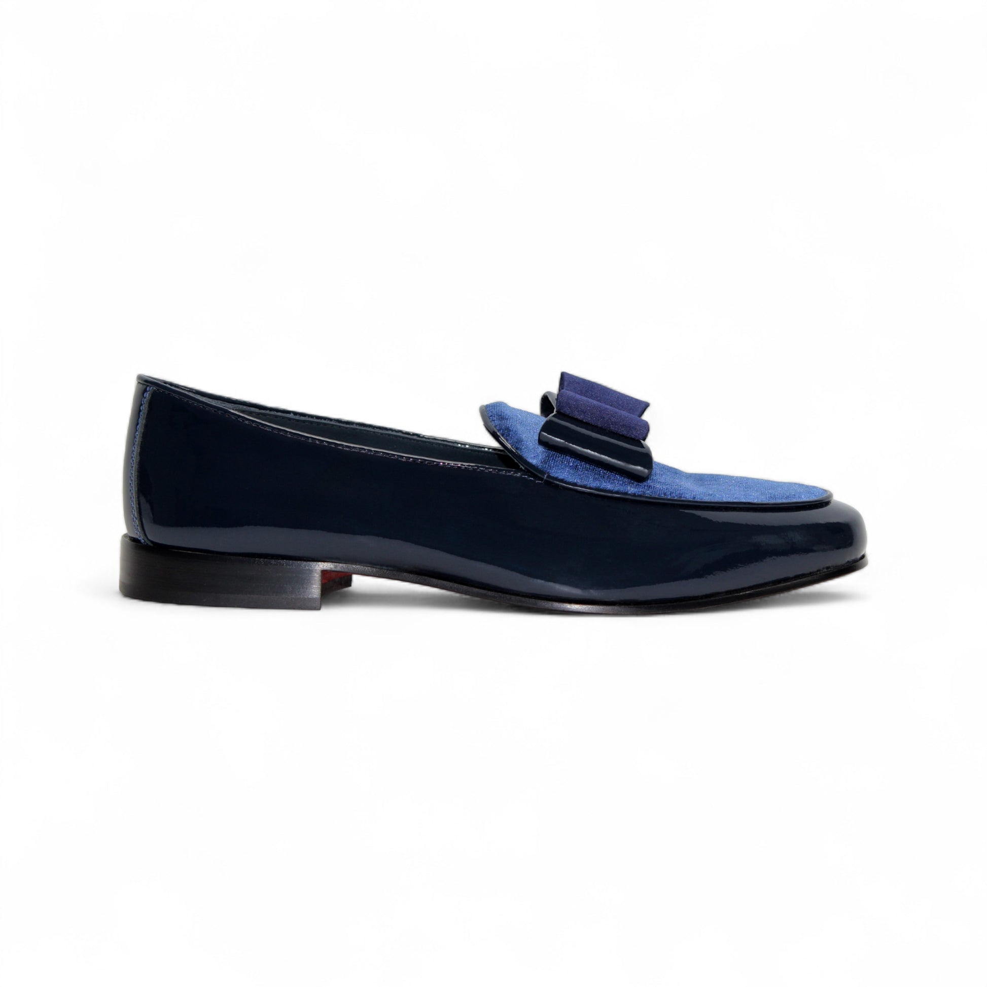 The Duca Amalfi Navy loafer by Duca Di Matiste features navy blue patent leather, a blue suede upper, and a stylish bow—shown in side profile on white, it's an elegant choice for your Italian luxury shoe collection.