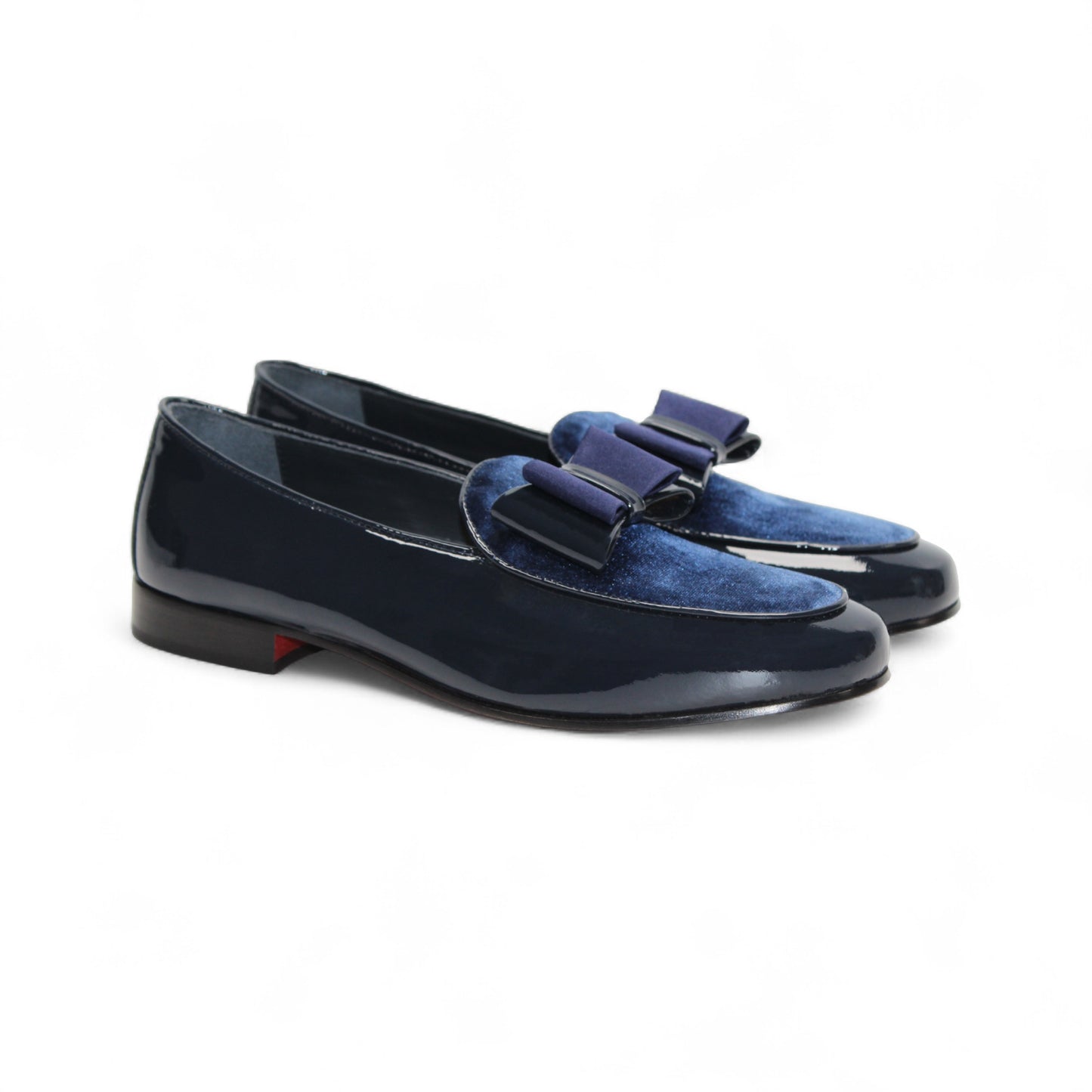 The Duca Amalfi Navy loafer by Duca Di Matiste features navy blue patent leather, a blue suede upper, and a stylish bow—shown in side profile on white, it's an elegant choice for your Italian luxury shoe collection.