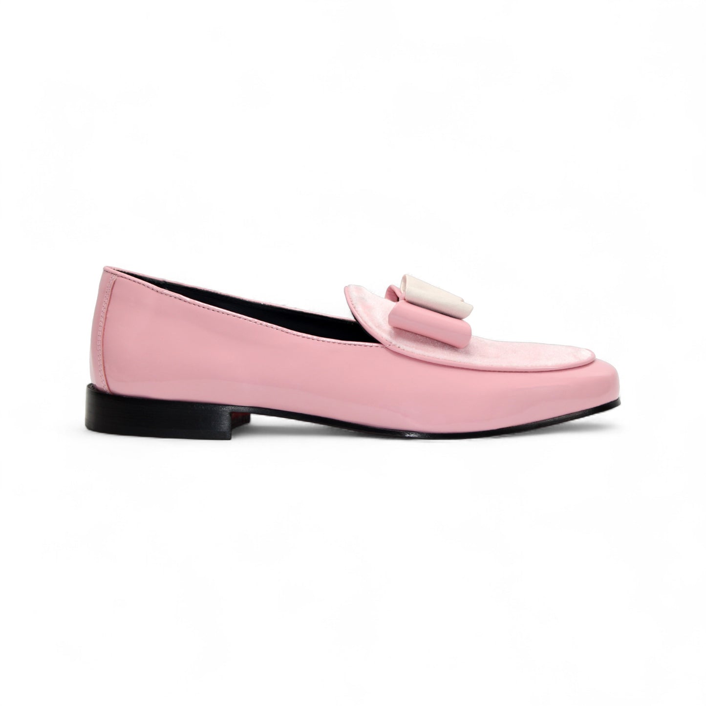 The Duca Amalfi Pink by Duca Di Matiste is a pink patent loafer with a low black heel and a rectangular buckle, inspired by Italian luxury shoes, shown in side view on a white background.
