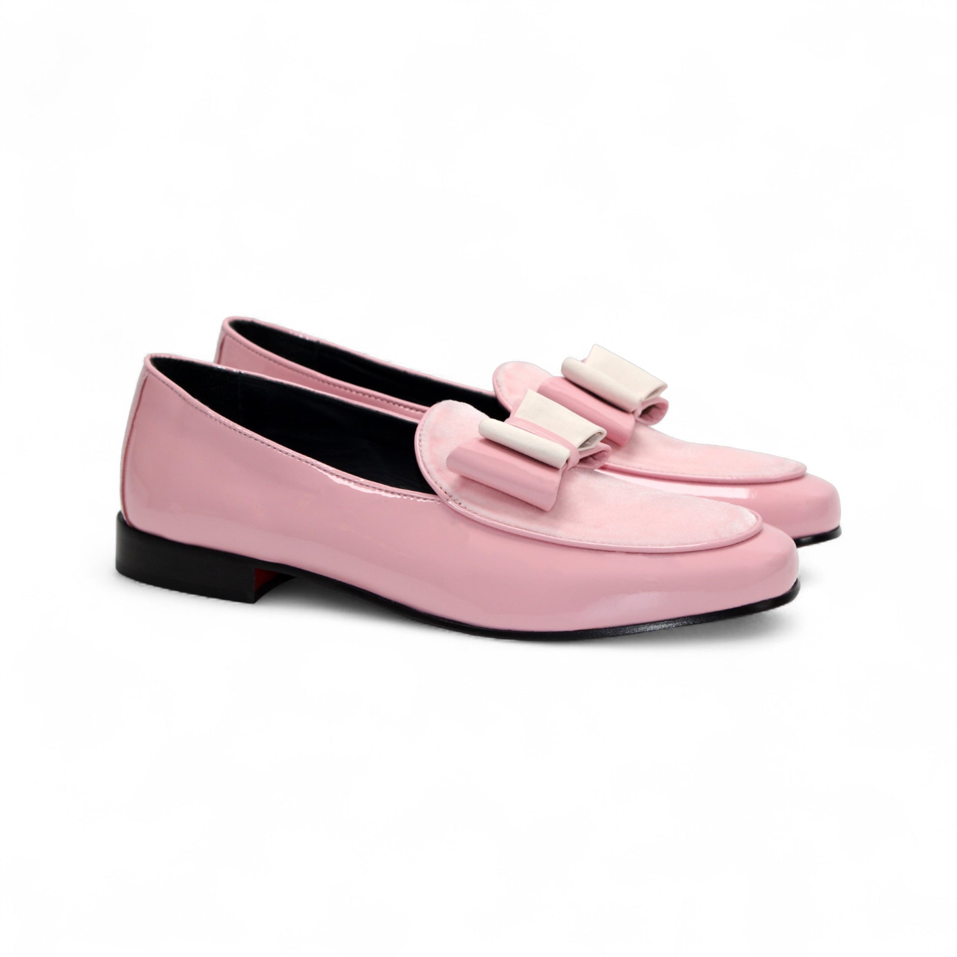The Duca Amalfi Pink by Duca Di Matiste is a pink patent loafer with a low black heel and a rectangular buckle, inspired by Italian luxury shoes, shown in side view on a white background.
