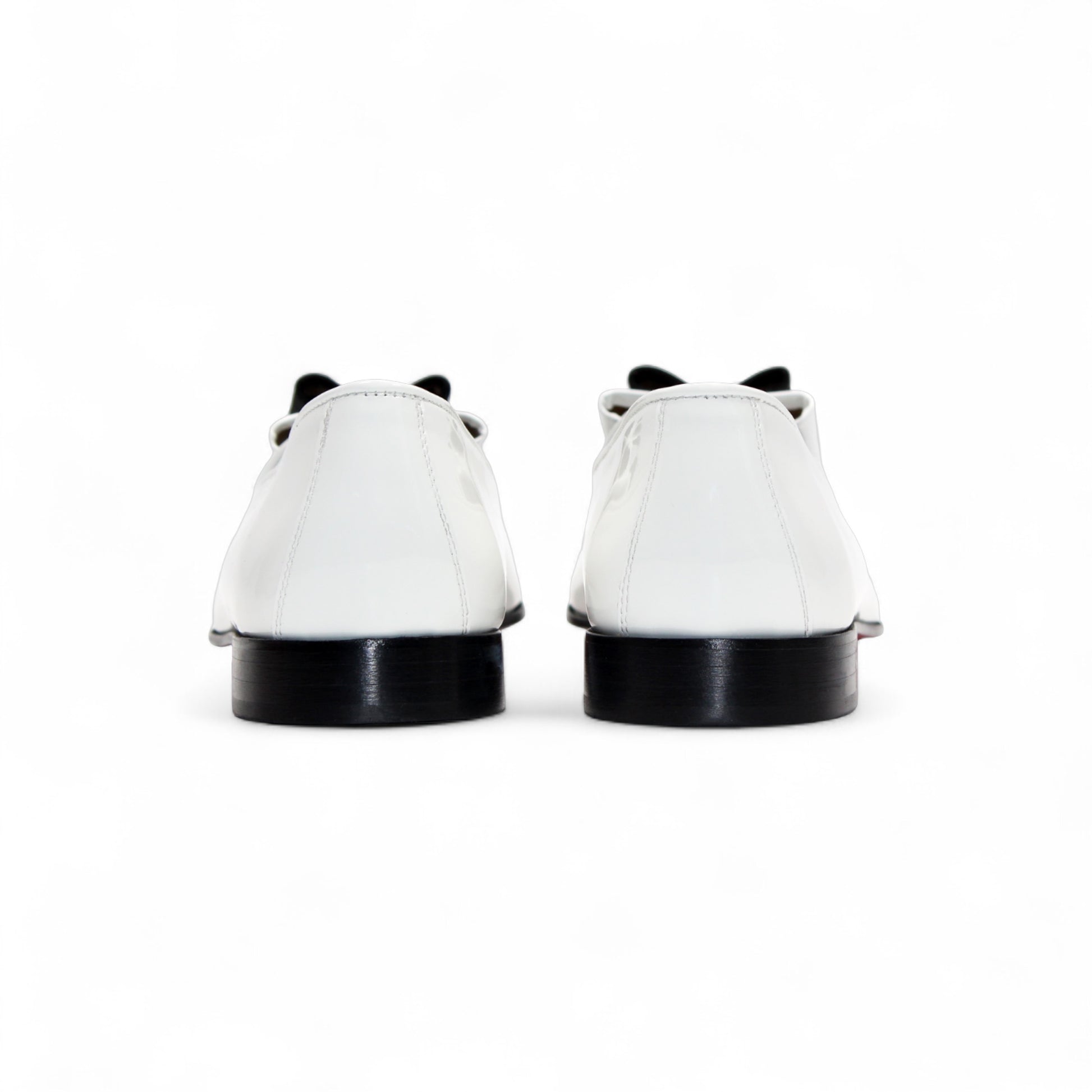 The Duca Di Matiste Duca Amalfi White/Black loafer features Italian-made white leather, a black sole, black upper detail, and a black and white bow, shown in side profile on a white background.