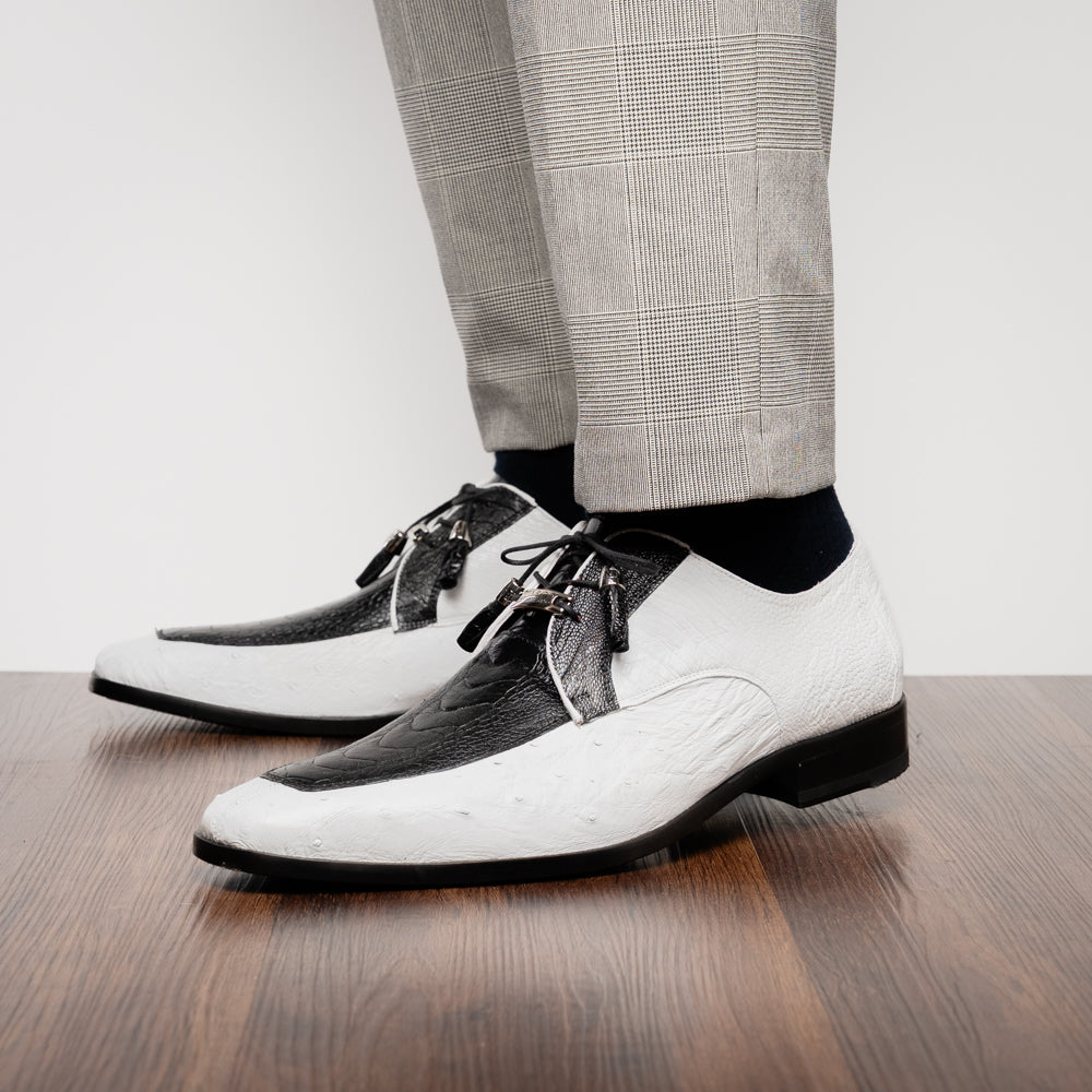 A pair of men’s luxury Andretti Black / White dress derby shoes from Marco Di Milano, these genuine ostrich leather shoes showcase elegant white uppers with black lace-up detailing; one shoe is shown upright while the other displays the rich brown sole.