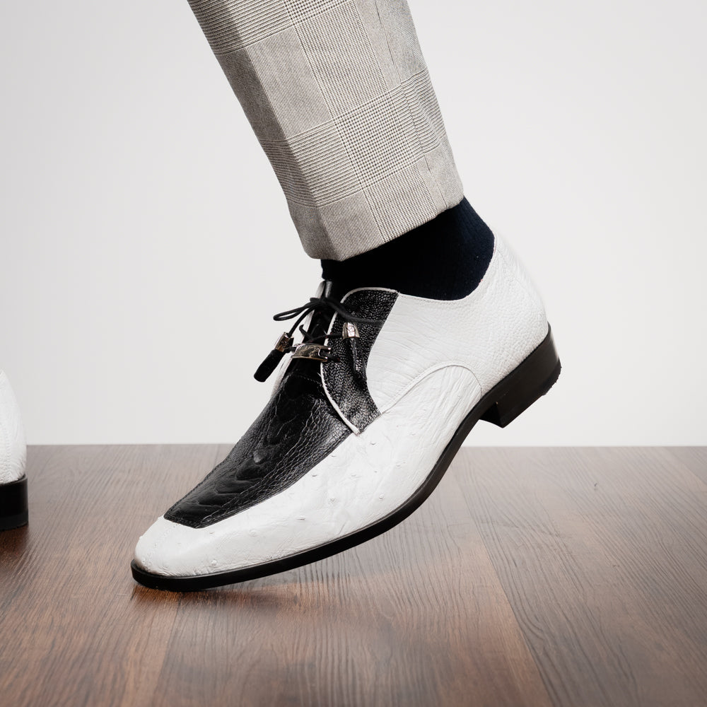 A pair of men’s luxury Andretti Black / White dress derby shoes from Marco Di Milano, these genuine ostrich leather shoes showcase elegant white uppers with black lace-up detailing; one shoe is shown upright while the other displays the rich brown sole.