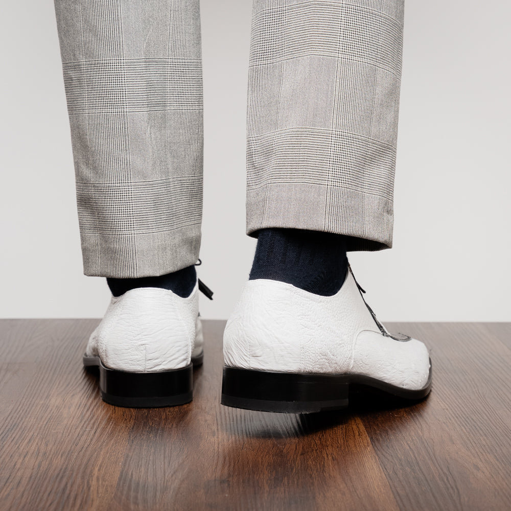 A pair of men’s luxury Andretti Black / White dress derby shoes from Marco Di Milano, these genuine ostrich leather shoes showcase elegant white uppers with black lace-up detailing; one shoe is shown upright while the other displays the rich brown sole.