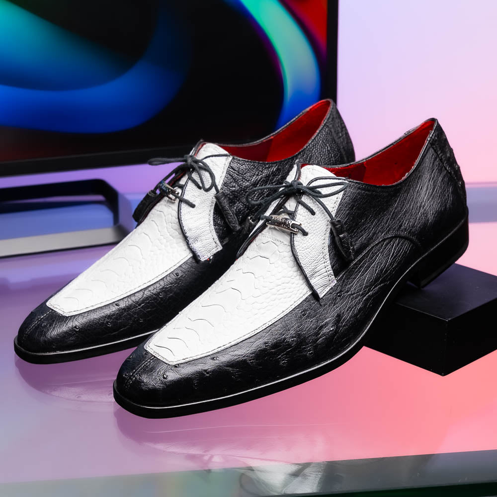 The Andretti White / Black by Marco Di Milano is a black and white leather dress shoe with a textured pattern, black laces, and a brown embossed leather sole—luxury footwear for any occasion.