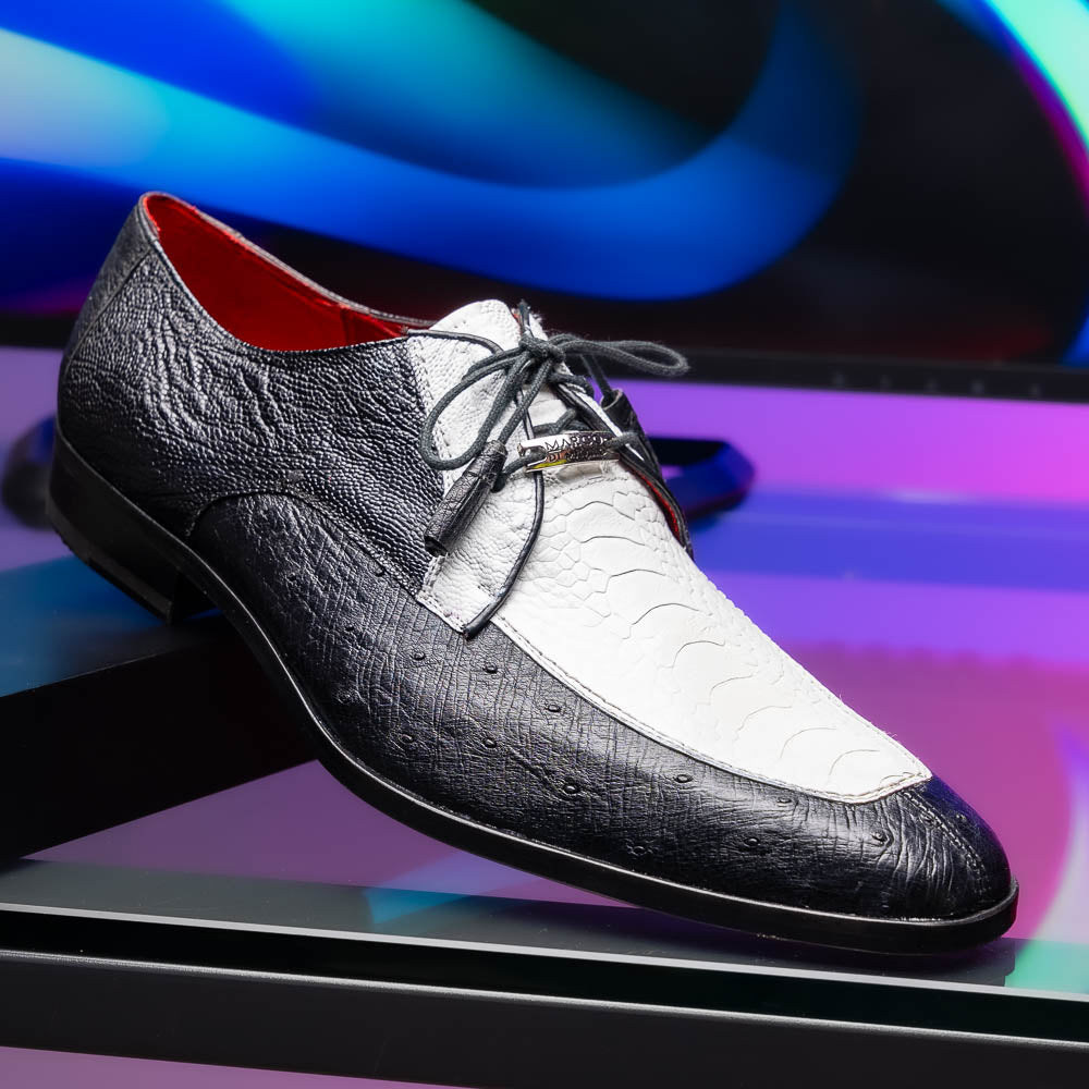 The Andretti White / Black by Marco Di Milano is a black and white leather dress shoe with a textured pattern, black laces, and a brown embossed leather sole—luxury footwear for any occasion.