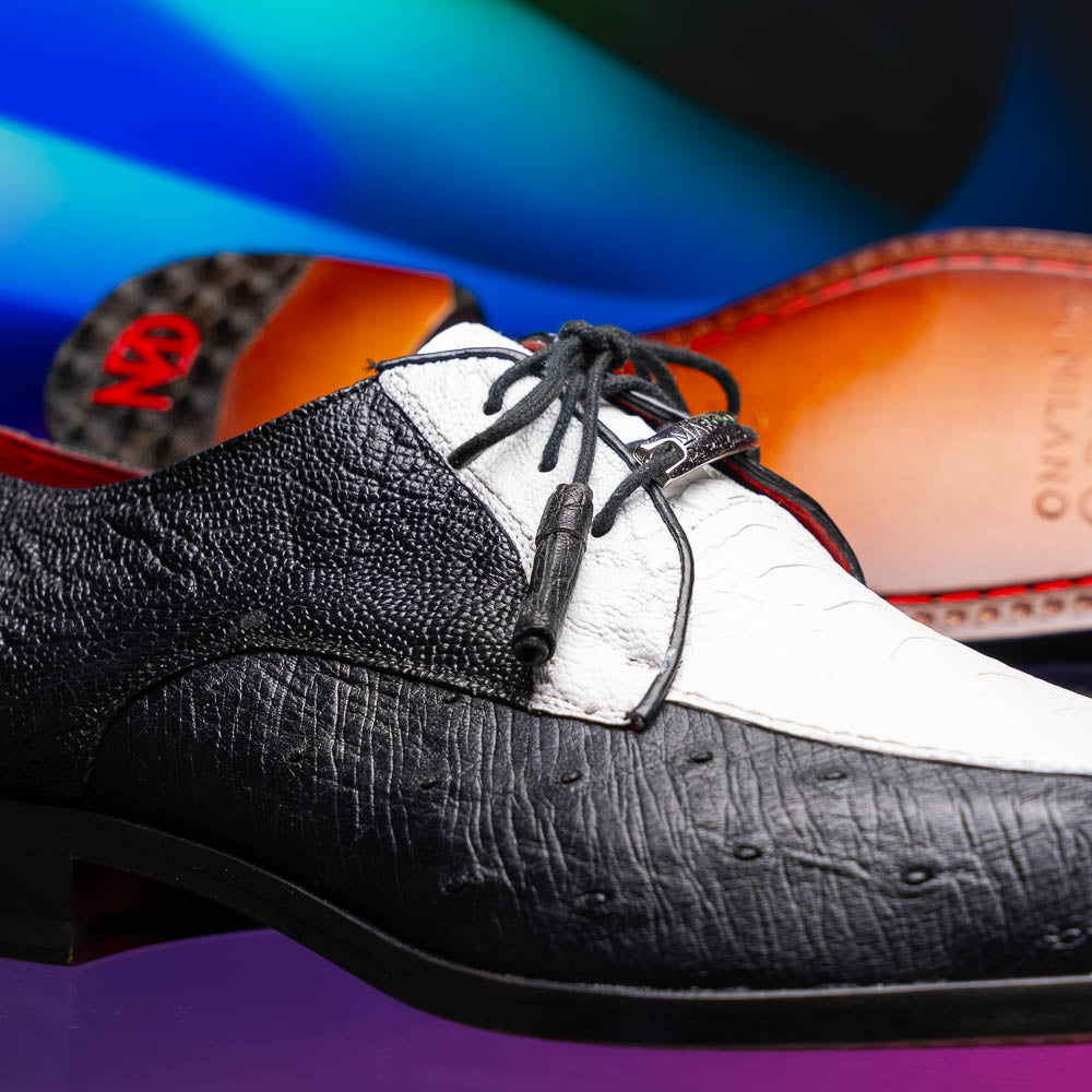 The Andretti White / Black by Marco Di Milano is a black and white leather dress shoe with a textured pattern, black laces, and a brown embossed leather sole—luxury footwear for any occasion.