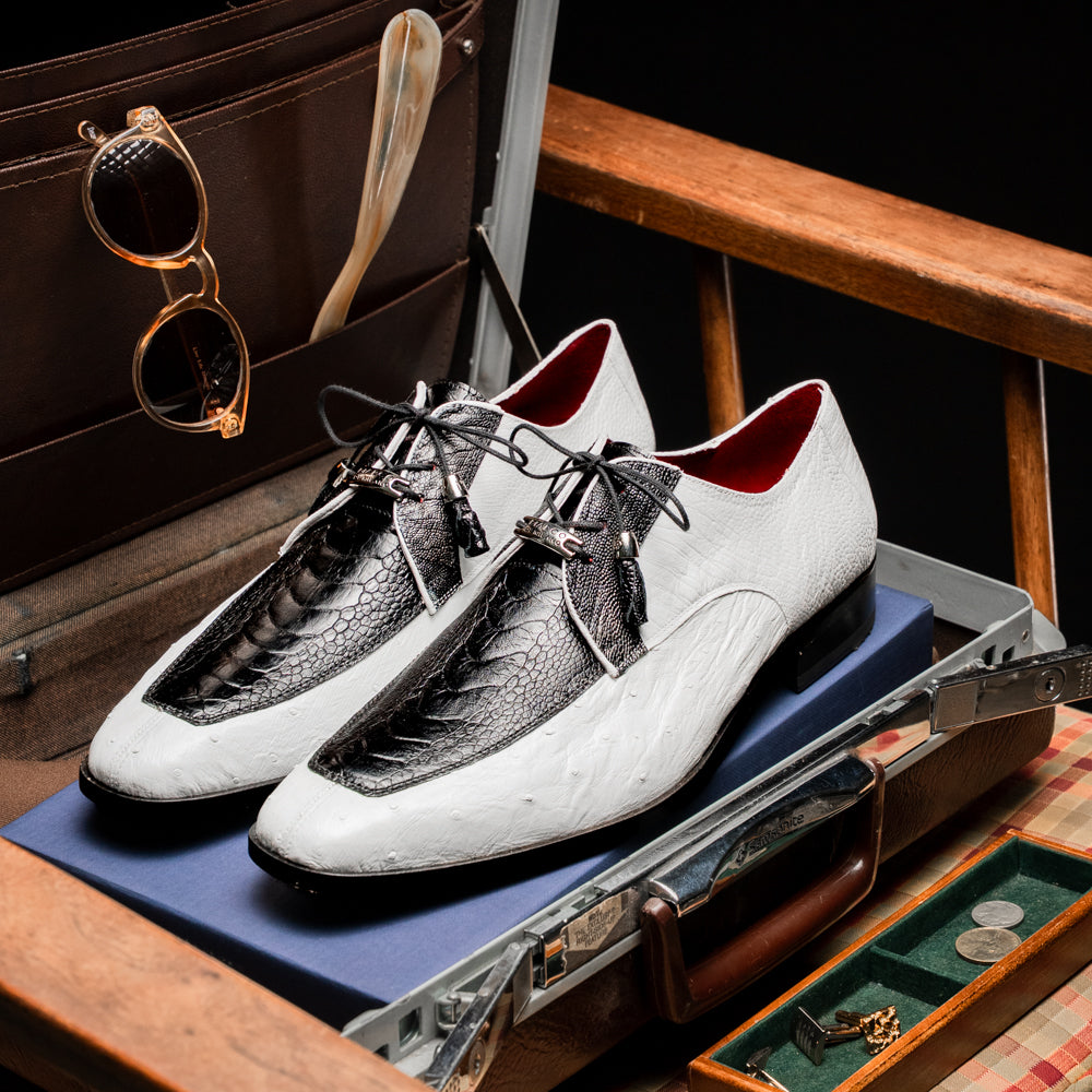 A pair of men’s luxury Andretti Black / White dress derby shoes from Marco Di Milano, these genuine ostrich leather shoes showcase elegant white uppers with black lace-up detailing; one shoe is shown upright while the other displays the rich brown sole.