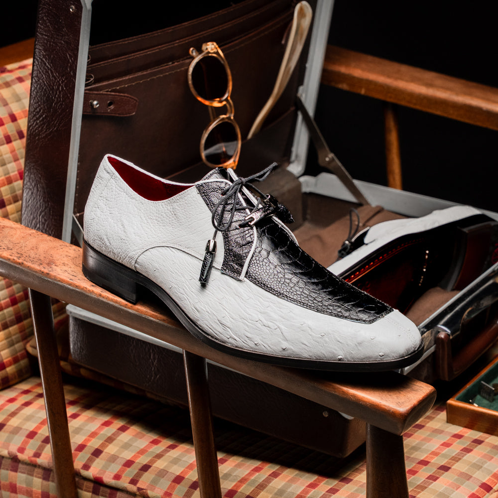 A pair of men’s luxury Andretti Black / White dress derby shoes from Marco Di Milano, these genuine ostrich leather shoes showcase elegant white uppers with black lace-up detailing; one shoe is shown upright while the other displays the rich brown sole.