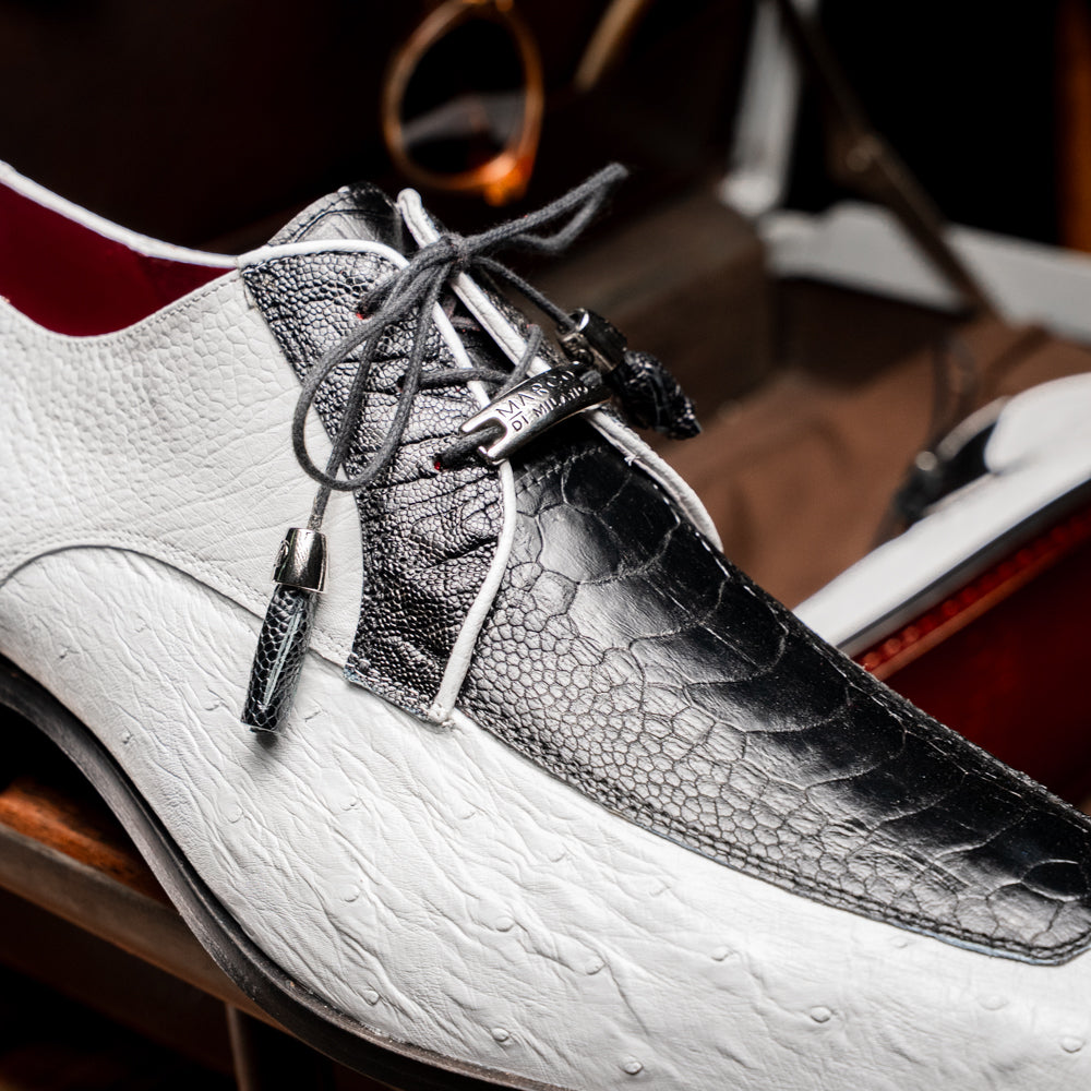 A pair of men’s luxury Andretti Black / White dress derby shoes from Marco Di Milano, these genuine ostrich leather shoes showcase elegant white uppers with black lace-up detailing; one shoe is shown upright while the other displays the rich brown sole.