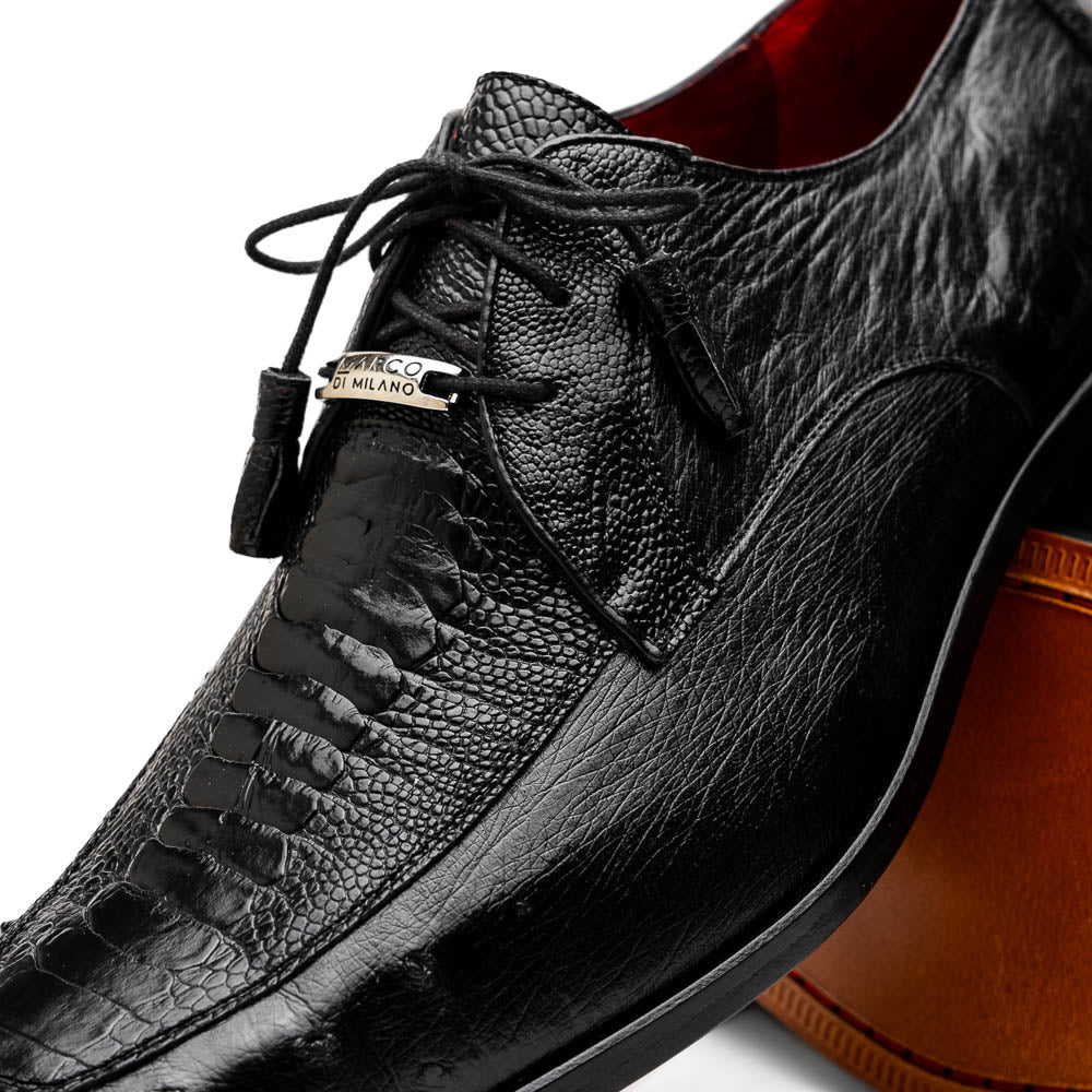 A pair of Andretti Black shoes by Marco Di Milano—one upright to reveal the textured upper, the other on its side showing the brown branded sole—showcasing luxury men's footwear.