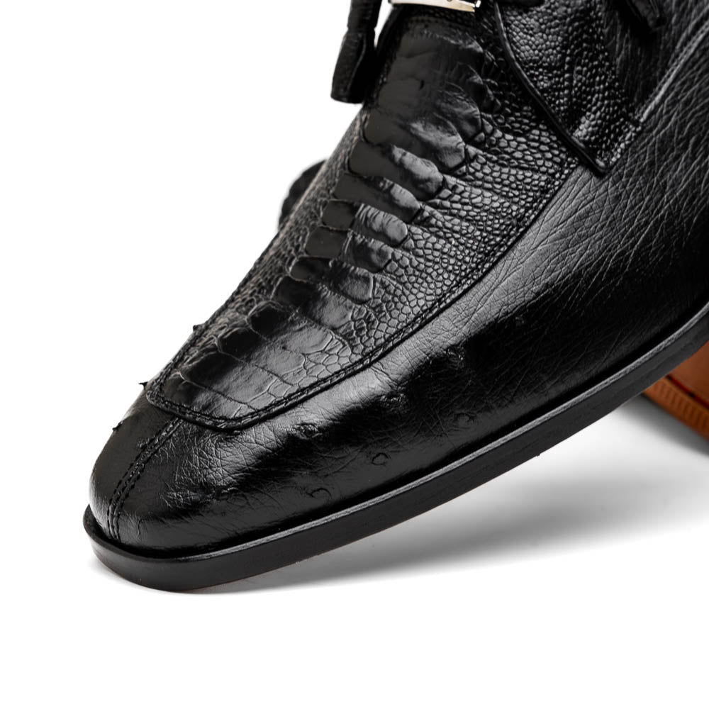 A pair of Andretti Black shoes by Marco Di Milano—one upright to reveal the textured upper, the other on its side showing the brown branded sole—showcasing luxury men's footwear.