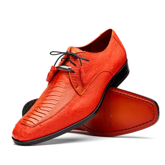 The Andretti Orange by Marco Di Milano are vibrant orange leather dress shoes with black laces and textured detailing, one upright and one showing the branded sole—ideal luxury footwear for men.
