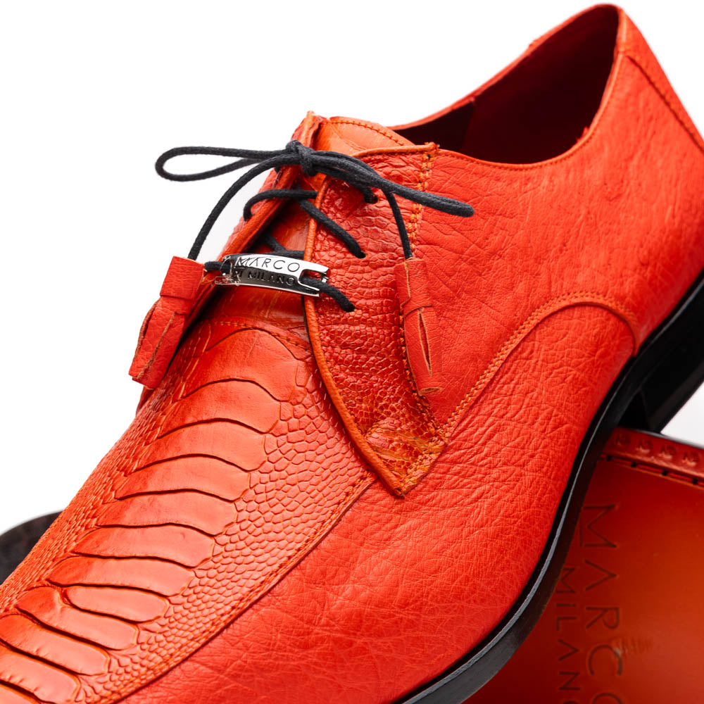 The Andretti Orange by Marco Di Milano are vibrant orange leather dress shoes with black laces and textured detailing, one upright and one showing the branded sole—ideal luxury footwear for men.