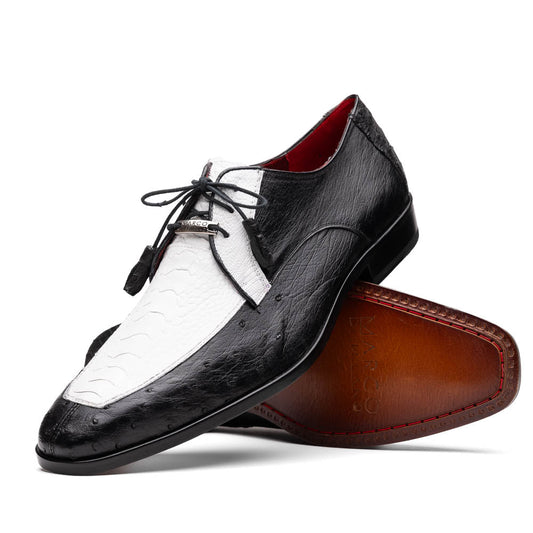 The Andretti White / Black by Marco Di Milano is a black and white leather dress shoe with a textured pattern, black laces, and a brown embossed leather sole—luxury footwear for any occasion.