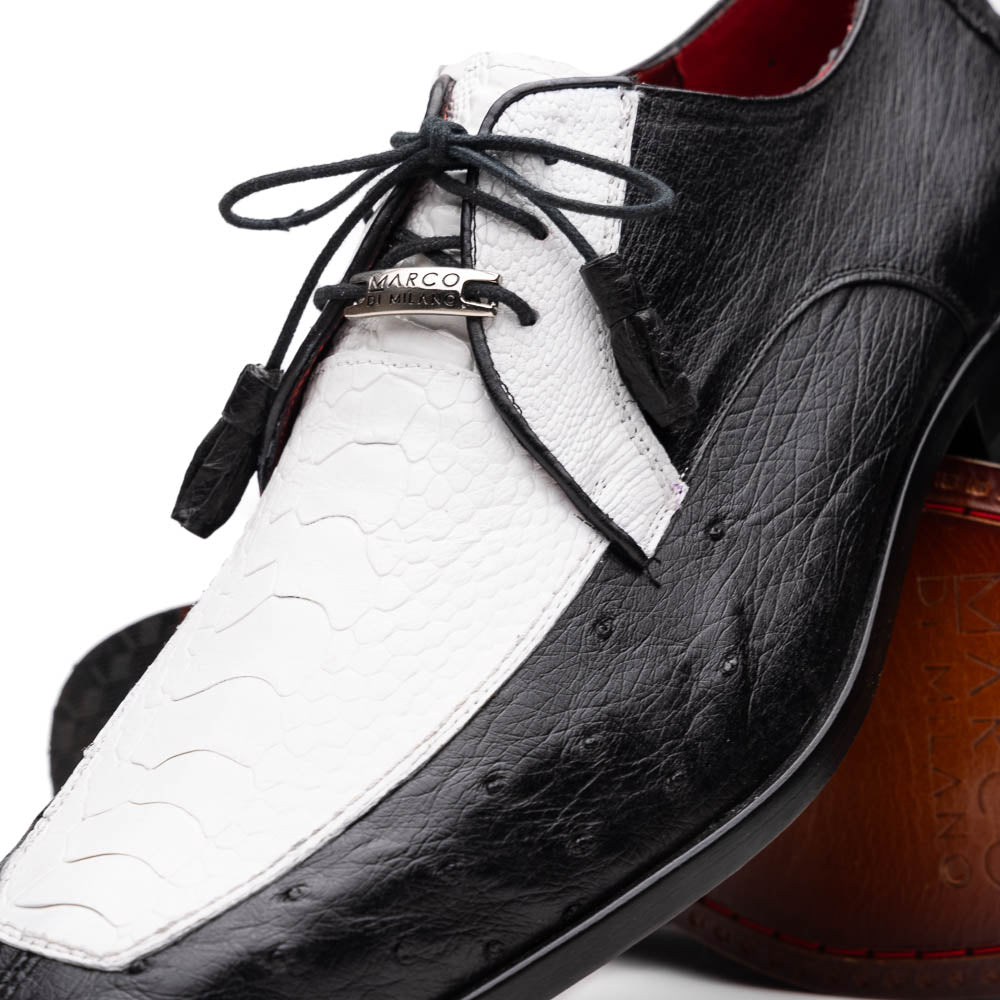 The Andretti White / Black by Marco Di Milano is a black and white leather dress shoe with a textured pattern, black laces, and a brown embossed leather sole—luxury footwear for any occasion.