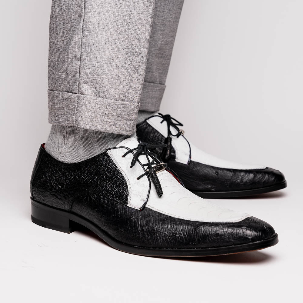 The Andretti White / Black by Marco Di Milano is a black and white leather dress shoe with a textured pattern, black laces, and a brown embossed leather sole—luxury footwear for any occasion.
