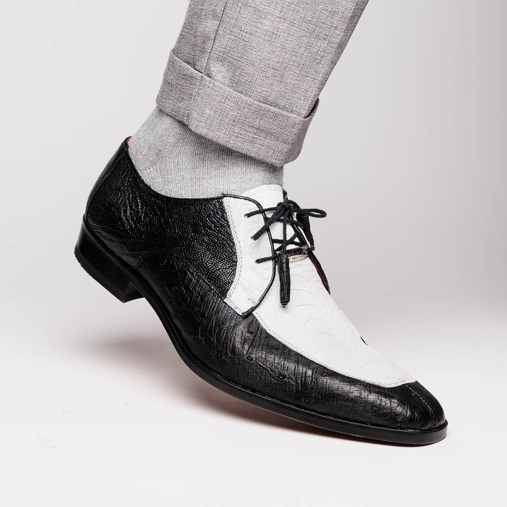 The Andretti White / Black by Marco Di Milano is a black and white leather dress shoe with a textured pattern, black laces, and a brown embossed leather sole—luxury footwear for any occasion.