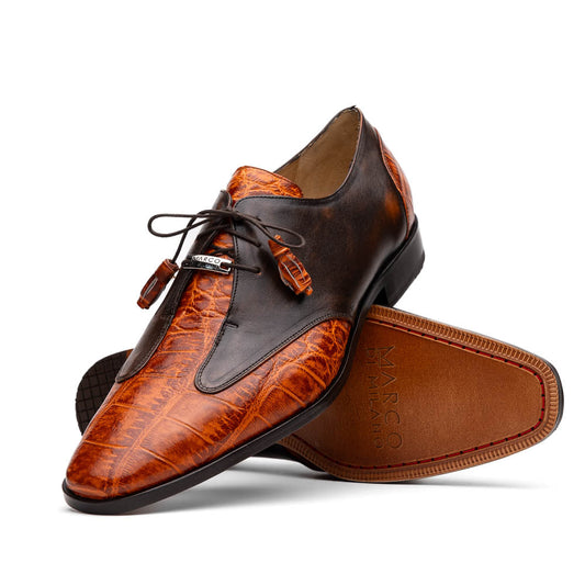 Step out in style with the Marco Di Milano Anzio Rustic Brandy men's leather dress shoes, showcasing a brown and orange crocodile pattern, lace-up closure, and "MARCO" branding—perfect for those who appreciate luxury footwear.