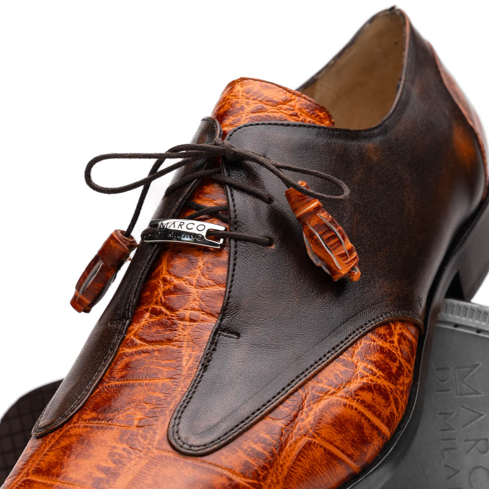 Step out in style with the Marco Di Milano Anzio Rustic Brandy men's leather dress shoes, showcasing a brown and orange crocodile pattern, lace-up closure, and "MARCO" branding—perfect for those who appreciate luxury footwear.