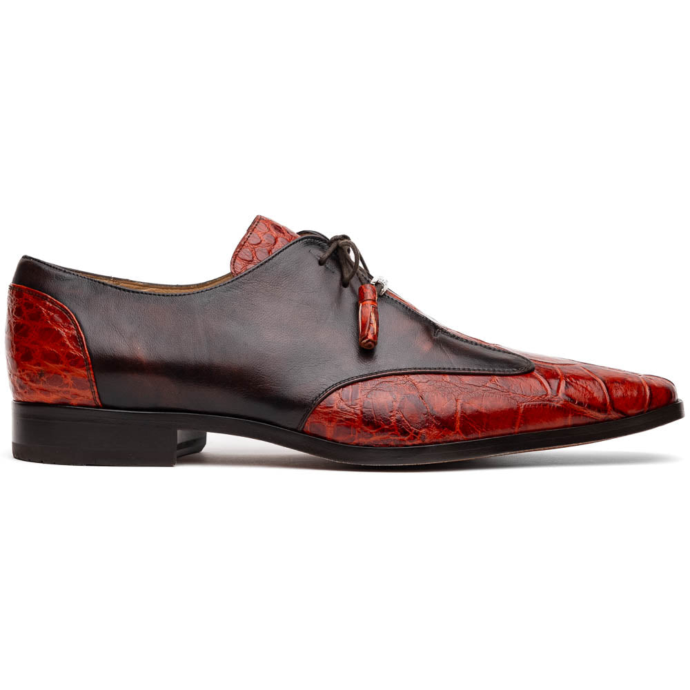 The Anzio Rustic Cognac by Marco Di Milano is a men's dress shoe featuring red and brown crocodile-patterned leather, lace-up closure, tassel accents, and leather soles—an elevated choice in luxury footwear.