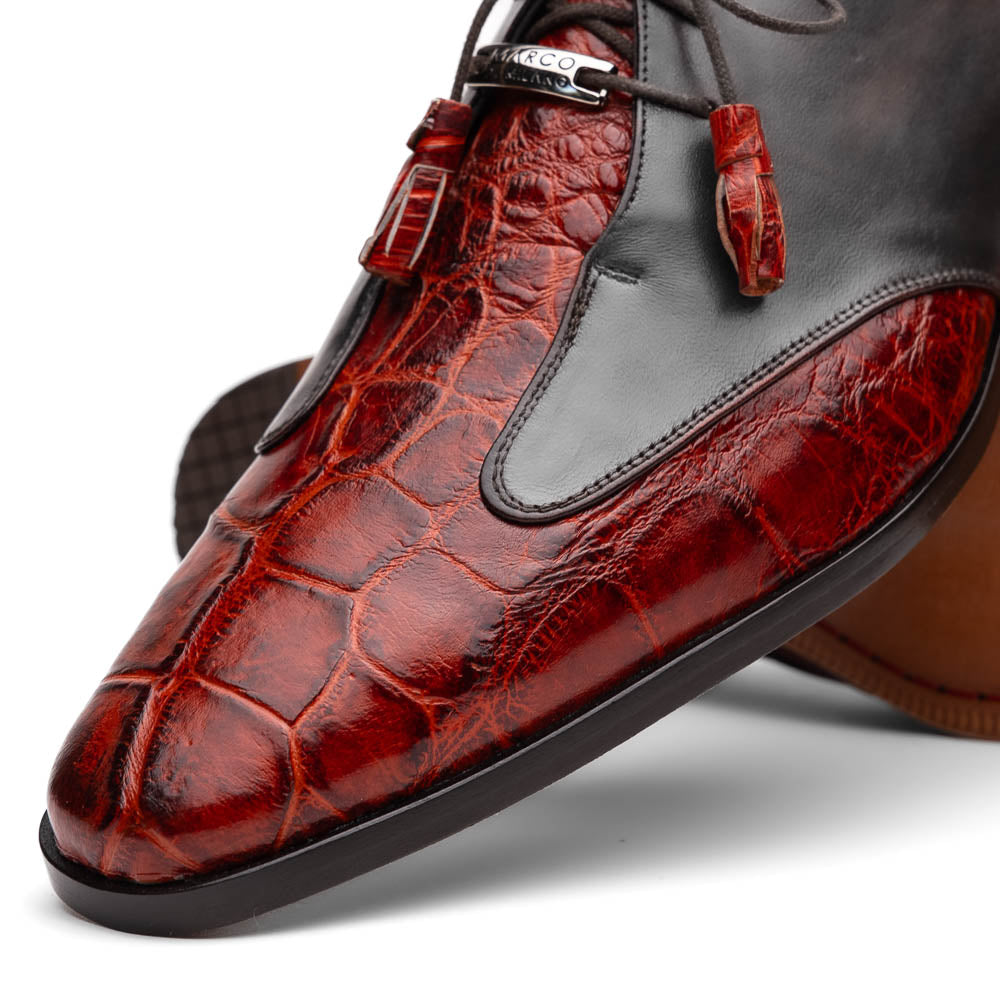 The Anzio Rustic Cognac by Marco Di Milano is a men's dress shoe featuring red and brown crocodile-patterned leather, lace-up closure, tassel accents, and leather soles—an elevated choice in luxury footwear.