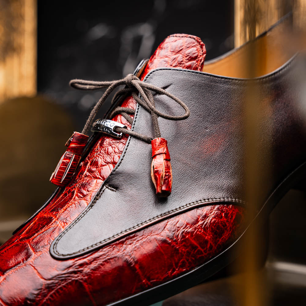 The Anzio Rustic Cognac by Marco Di Milano is a men's dress shoe featuring red and brown crocodile-patterned leather, lace-up closure, tassel accents, and leather soles—an elevated choice in luxury footwear.