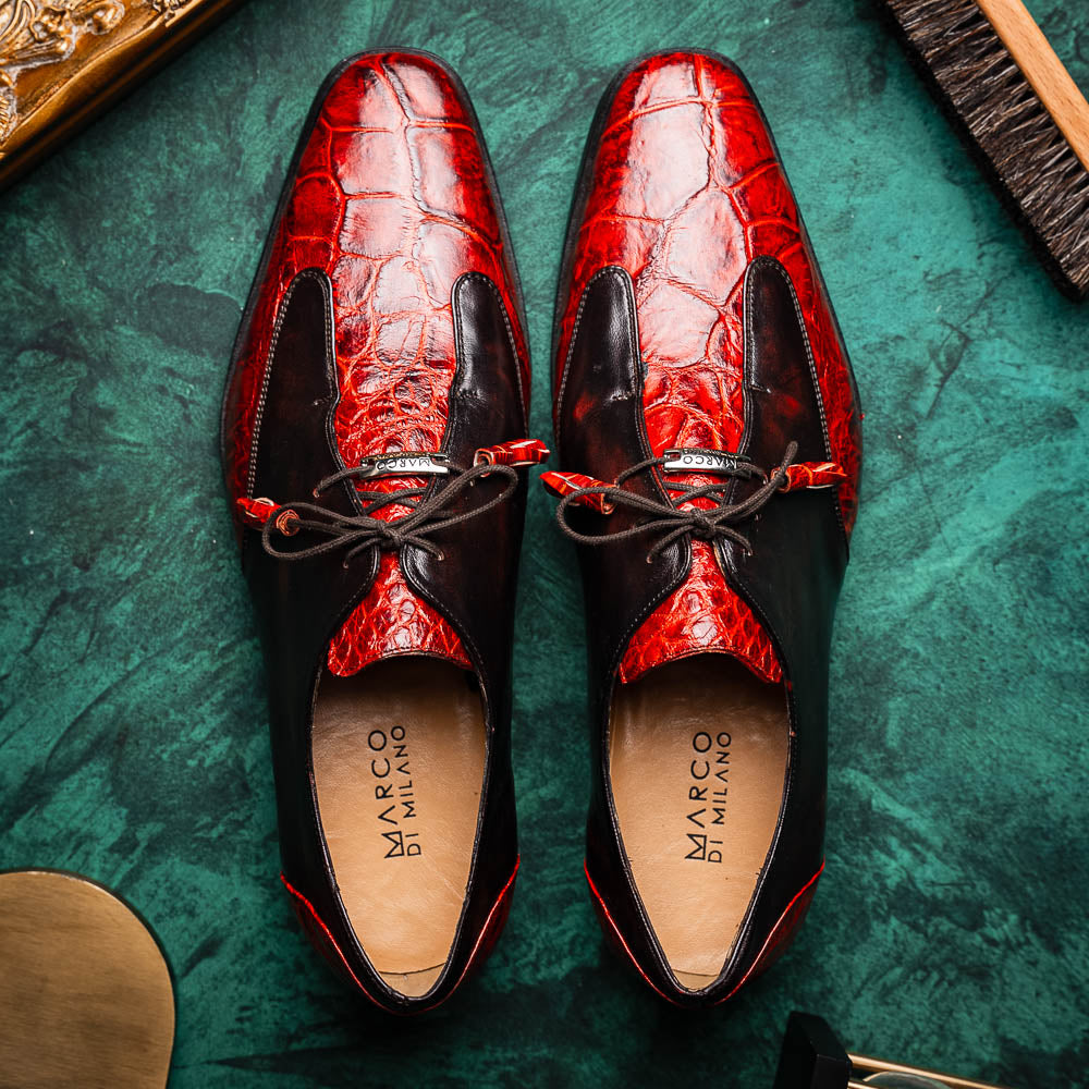 The Anzio Rustic Cognac by Marco Di Milano is a men's dress shoe featuring red and brown crocodile-patterned leather, lace-up closure, tassel accents, and leather soles—an elevated choice in luxury footwear.