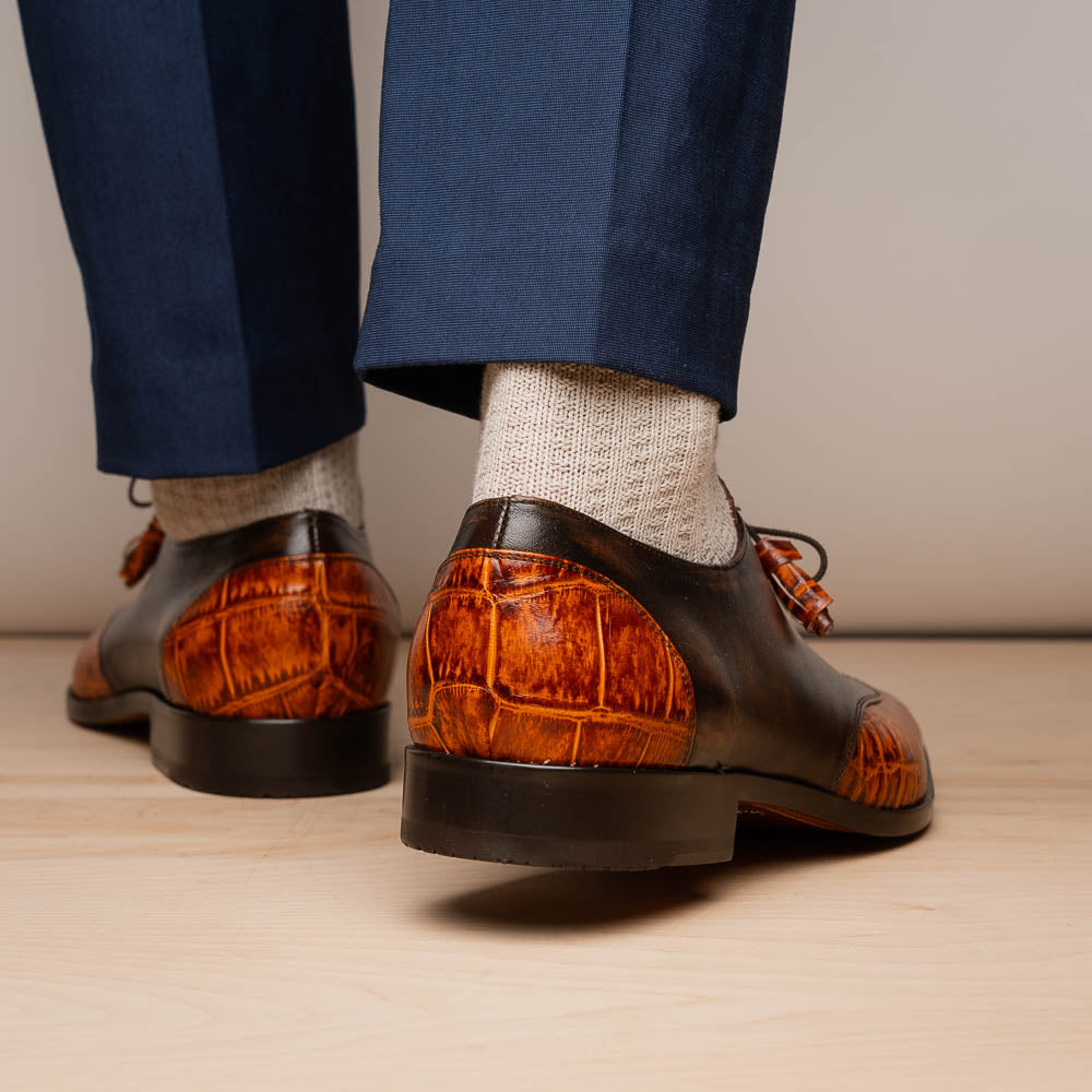 Step out in style with the Marco Di Milano Anzio Rustic Brandy men's leather dress shoes, showcasing a brown and orange crocodile pattern, lace-up closure, and "MARCO" branding—perfect for those who appreciate luxury footwear.