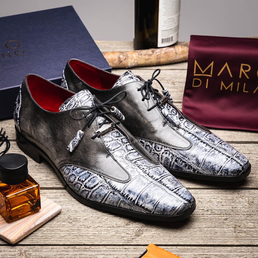 The Anzio Newspaper by Marco Di Milano is a luxury men's shoe with black leather, gray crocodile-pattern texture, brown leather soles, and black laces.