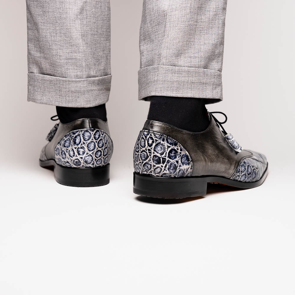 The Anzio Newspaper by Marco Di Milano is a luxury men's shoe with black leather, gray crocodile-pattern texture, brown leather soles, and black laces.