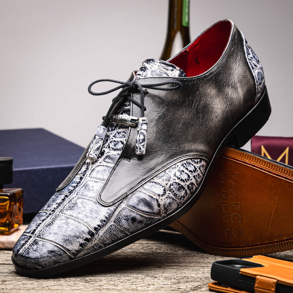 The Anzio Newspaper by Marco Di Milano is a luxury men's shoe with black leather, gray crocodile-pattern texture, brown leather soles, and black laces.
