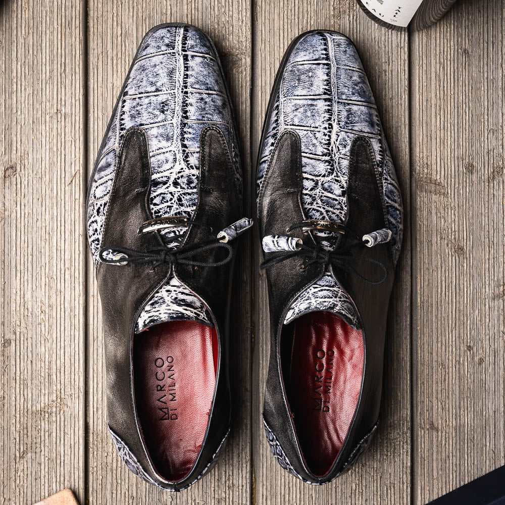 The Anzio Newspaper by Marco Di Milano is a luxury men's shoe with black leather, gray crocodile-pattern texture, brown leather soles, and black laces.