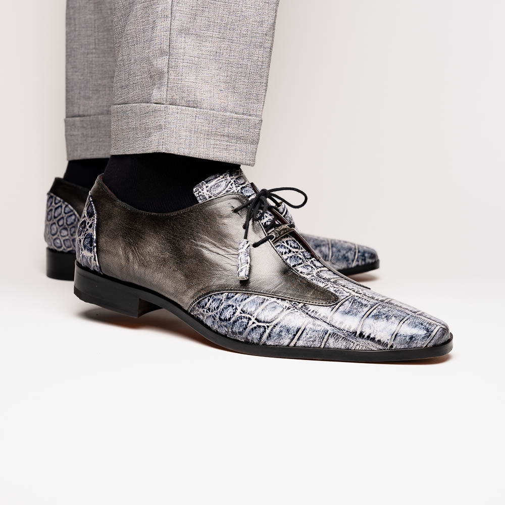The Anzio Newspaper by Marco Di Milano is a luxury men's shoe with black leather, gray crocodile-pattern texture, brown leather soles, and black laces.