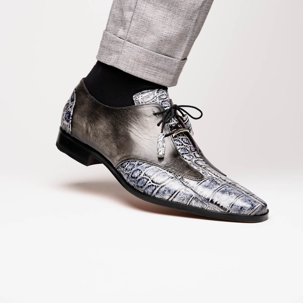 The Anzio Newspaper by Marco Di Milano is a luxury men's shoe with black leather, gray crocodile-pattern texture, brown leather soles, and black laces.