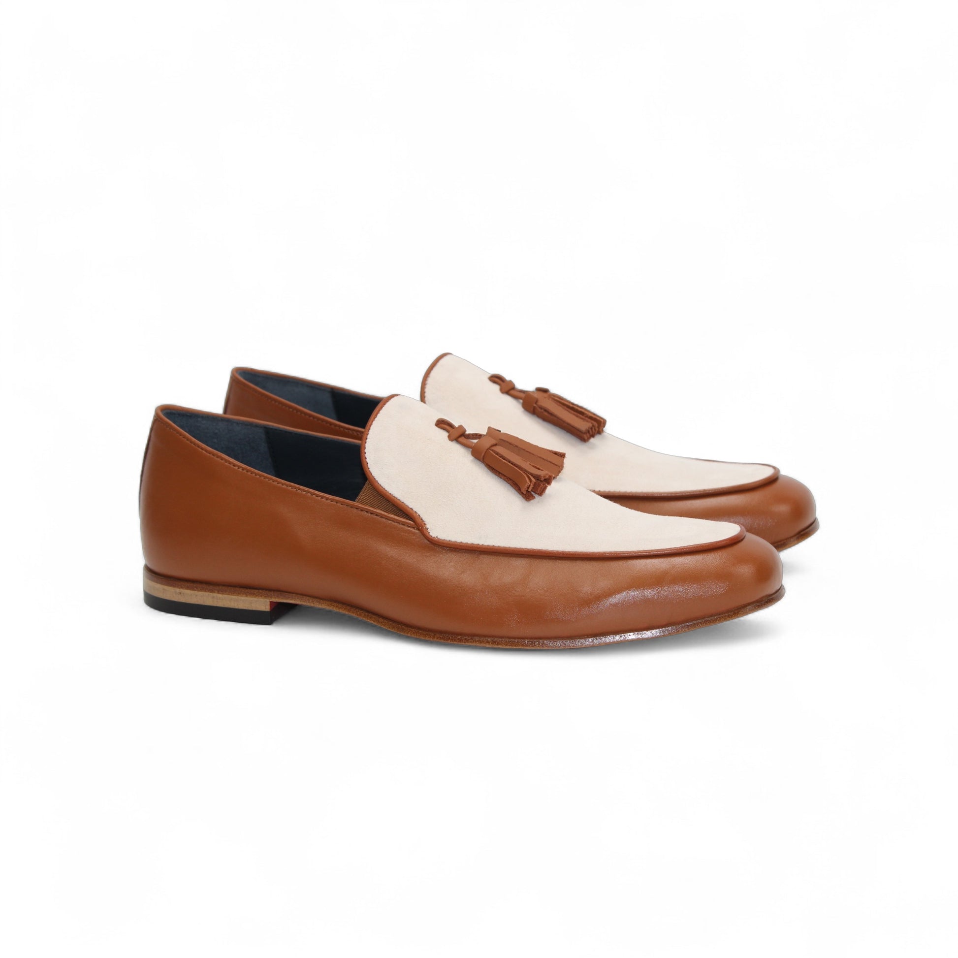 The Duca Di Matiste Duca Anzio Brandy/Bone loafer in brown and beige leather with tassel detail and a suede bottom, shown from the side against a white background.