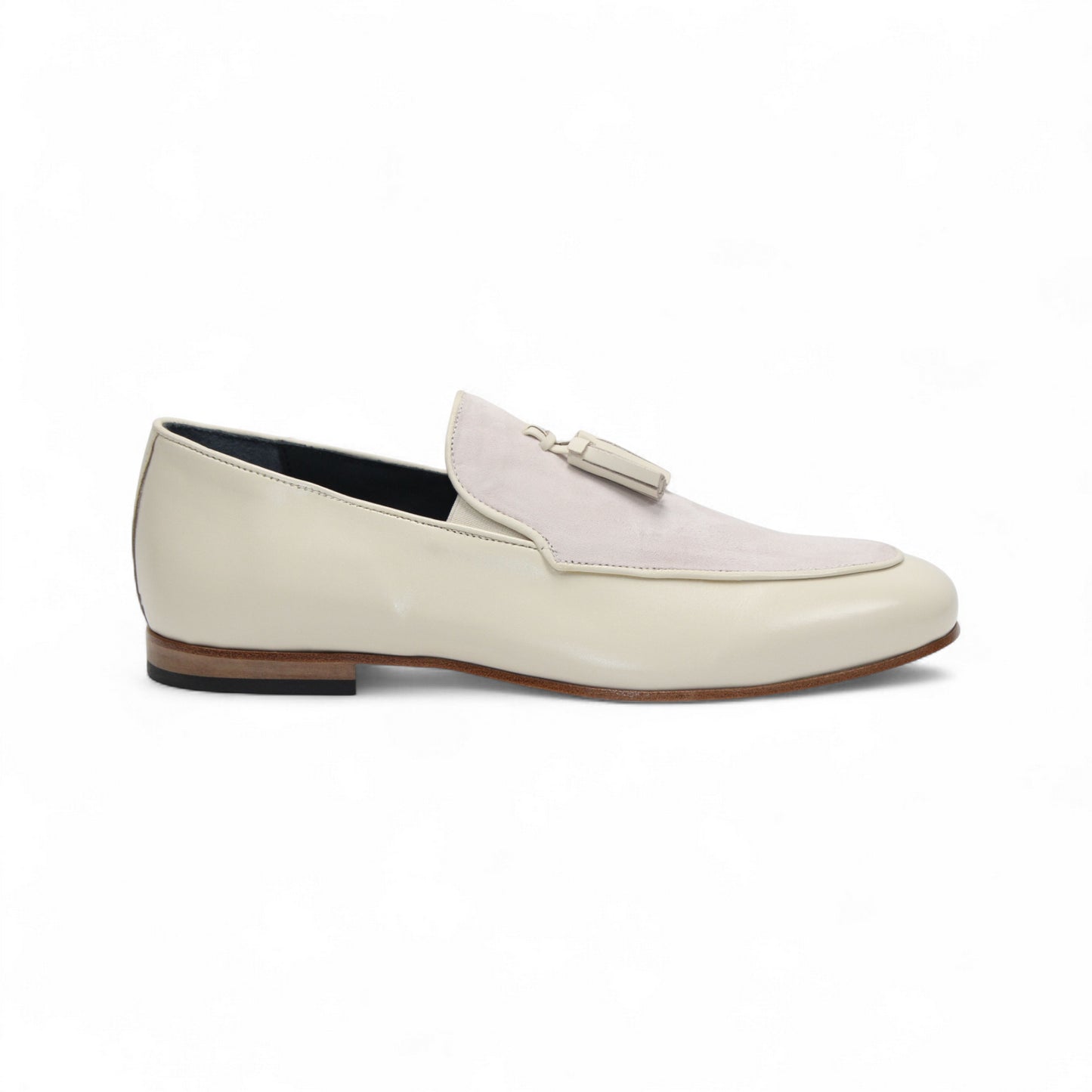The Duca Anzio Cream by Duca Di Matiste is a men's loafer featuring cream and light beige tones, tassel detail, low wooden heel, and a smooth leather finish for refined minimalist style in a sleek side profile.