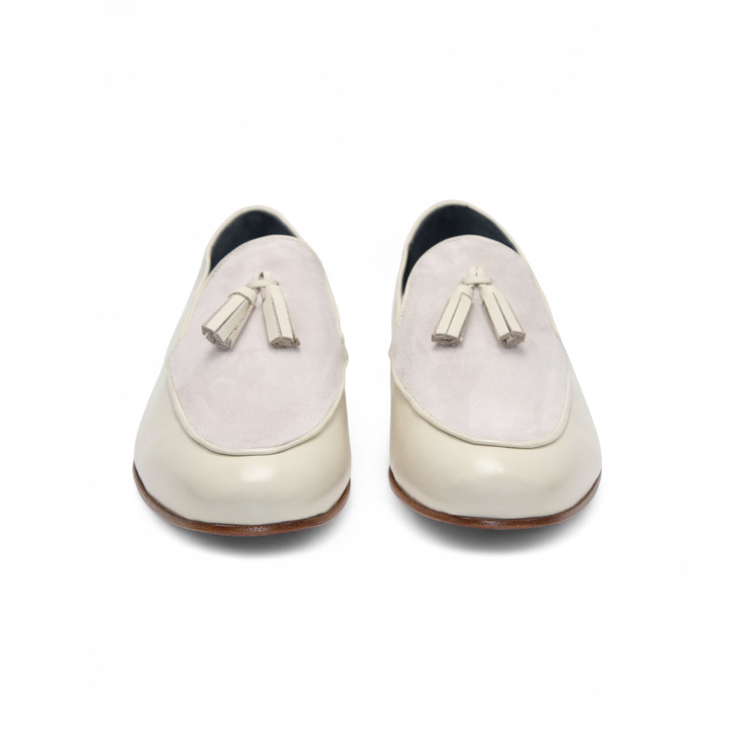 The Duca Anzio Cream by Duca Di Matiste is a men's loafer featuring cream and light beige tones, tassel detail, low wooden heel, and a smooth leather finish for refined minimalist style in a sleek side profile.