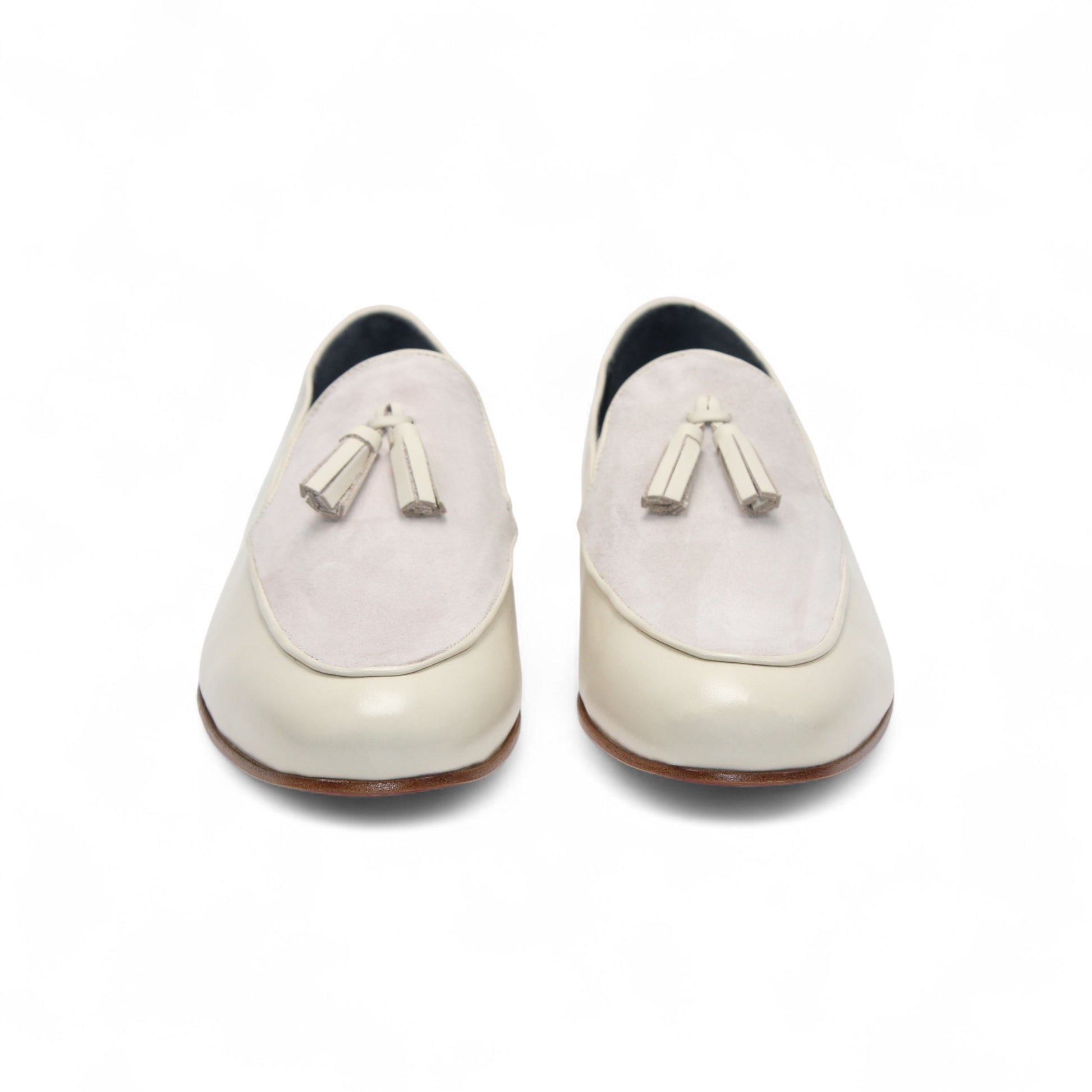 The Duca Anzio Cream by Duca Di Matiste is a men's loafer featuring cream and light beige tones, tassel detail, low wooden heel, and a smooth leather finish for refined minimalist style in a sleek side profile.