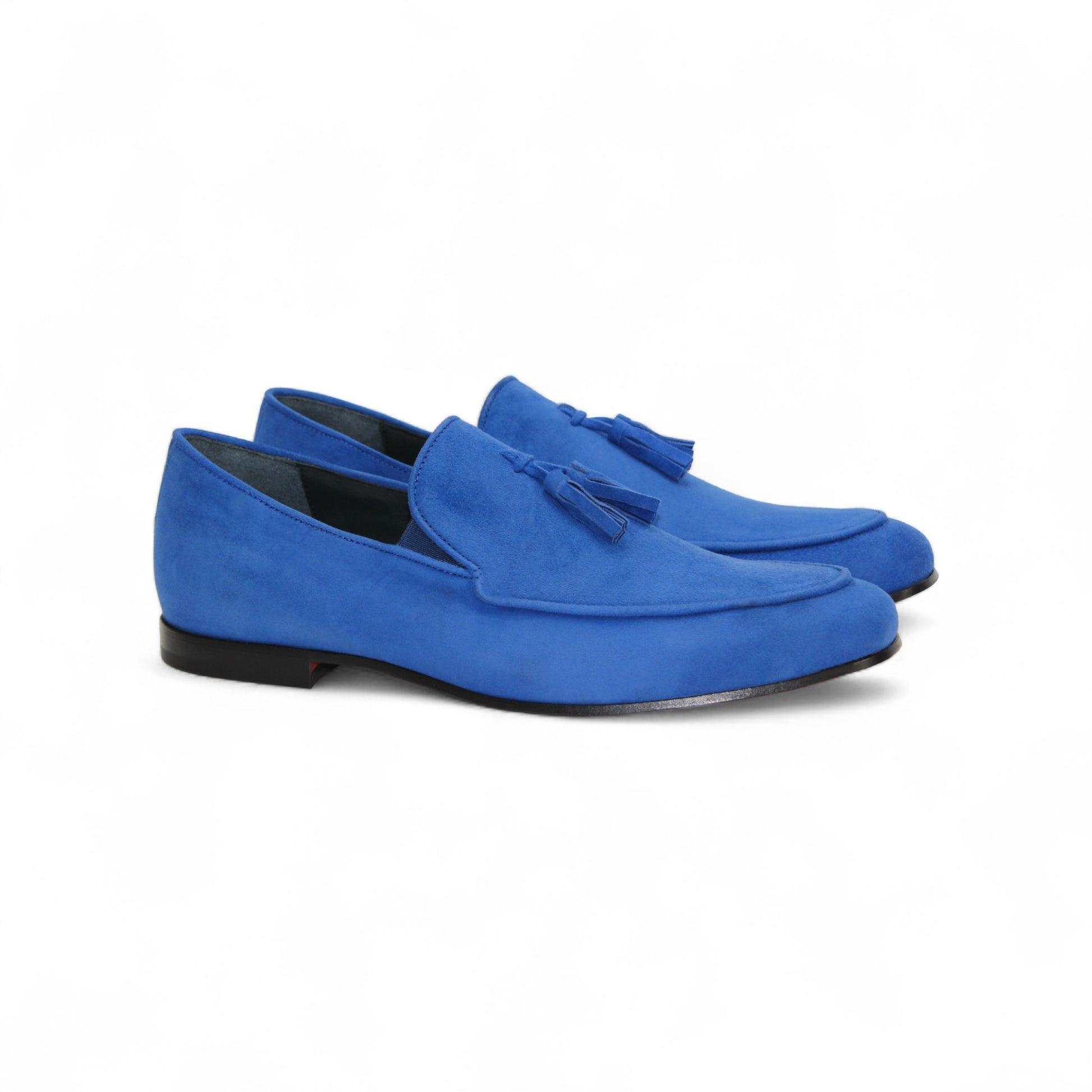 The Duca Di Matiste Duca Anzio Saphire is a blue suede loafer with tassel detailing and a leather sole, made in Italy, shown from the side against a white background.