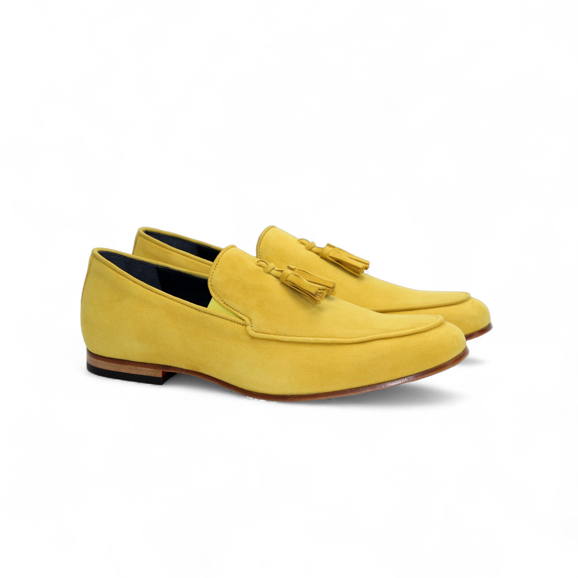 The Duca Di Matiste Duca Anzio Yellow is a single yellow suede loafer made in Italy, featuring a tassel detail, low wooden heel, and stitched trim, shown in profile against a white background.