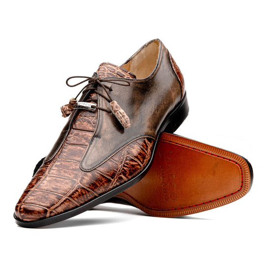 A pair of Anzio Rustic Orix brown leather dress shoes by Marco Di Milano, featuring a textured crocodile pattern—one upright, the other showing a smooth tan sole—represent true luxury men's footwear.