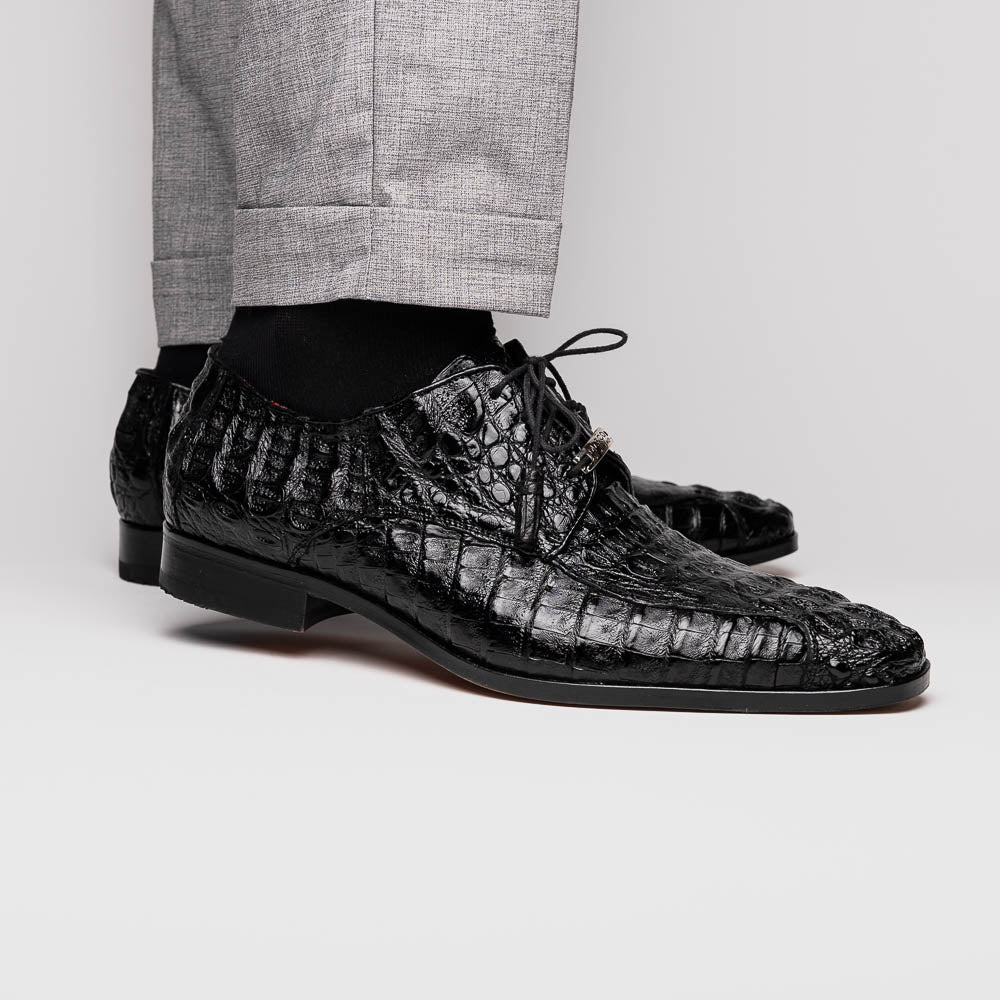 A pair of Marco Di Milano Apricena Black luxury men's dress shoes in genuine caiman crocodile leather with red interior lining and tan leather soles—one upright, the other lying stylishly on its side.