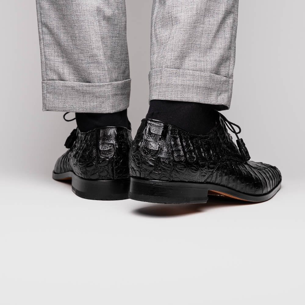 A pair of Marco Di Milano Apricena Black luxury men's dress shoes in genuine caiman crocodile leather with red interior lining and tan leather soles—one upright, the other lying stylishly on its side.
