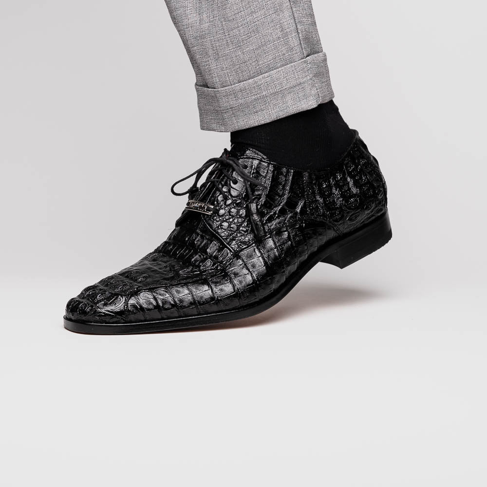 A pair of Marco Di Milano Apricena Black luxury men's dress shoes in genuine caiman crocodile leather with red interior lining and tan leather soles—one upright, the other lying stylishly on its side.
