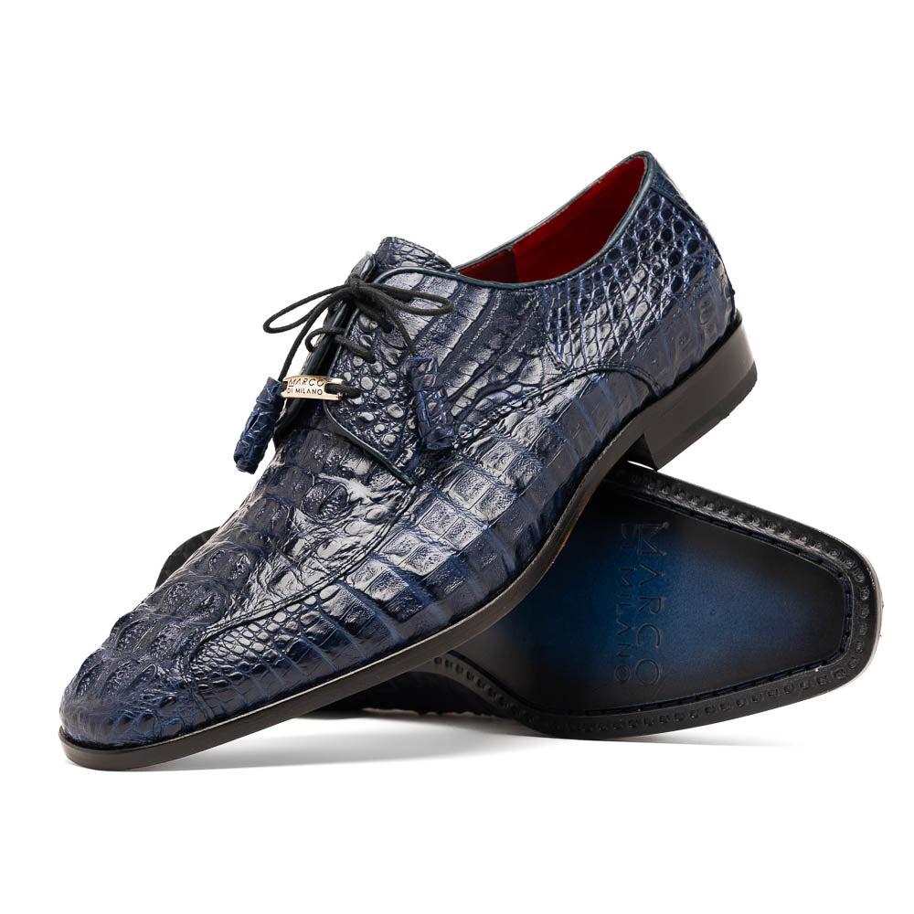A pair of Marco Di Milano Apricena Midnight Blue caiman crocodile derby shoes, one upright and the other on its side showing the sole, with black laces for a luxury dress look.