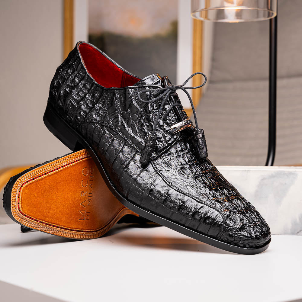 A pair of Marco Di Milano Apricena Black luxury men's dress shoes in genuine caiman crocodile leather with red interior lining and tan leather soles—one upright, the other lying stylishly on its side.